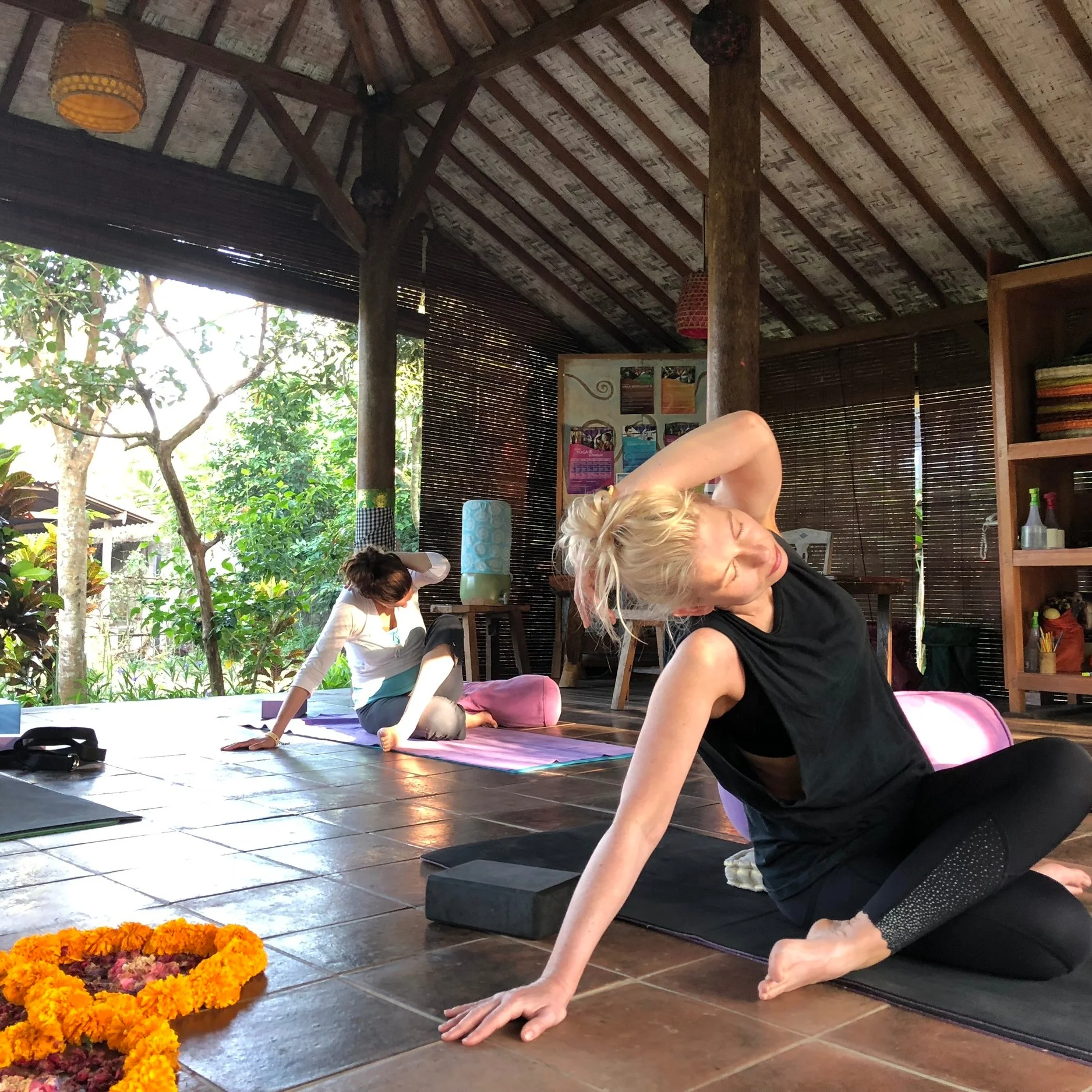 A stretch class in the open-air yoga shala